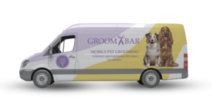 A picture of a mobile grooming van with the groombar logo on the side