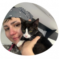 A picture of Sabrina with a black and white cat